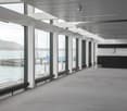 large windows, sea view, metal railing, white ceiling, white walls