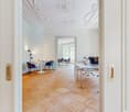 empty office room, wooden floor, white walls, chairs, tables, computer, lamp