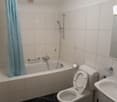 Bathroom: bathtub, shower, toilet, sink, mirror, exhaust fan