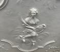 white ceiling with a female figure in relief, holding a mirror and a sword