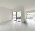 empty room, white walls, white tile flooring, sliding glass doors, balcony, mountain view