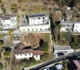Aerial view, 5 houses, solar panels on roofs, trees and plants, garage, driveway, road