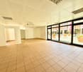 empty room, square tiles, double doors, windows, hallway