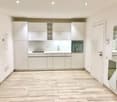 white cabinets, sink, dishwasher, oven, tiled floor