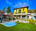 2 story house, yellow painted, balcony, swimming pool, well kept garden, stone wall