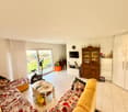 2 sofas, central table, TV, window, cabinet, door, clock, fitness bike
