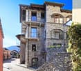 Stone exterior, multistory, several balconies, street view, steep slope