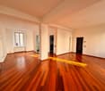 empty room, hardwood floors, white walls, windows, radiator