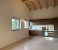 modern kitchen with wooden cabinets, stainless steel appliances, large windows, wooden beams, power outlets, tiled floor