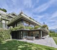 modern architecture, raised ground floor, large windows, balconies, covered terrace
