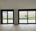 sliding glass doors, wooden floor, view of mountain and grassy area