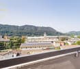 View from balcony of the surrounding area with buildings and mountains