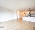 modern open kitchen, kitchen island, wooden floor, white walls, large windows, kitchen appliances