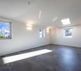 empty room, large windows, tile flooring, white walls, skylight