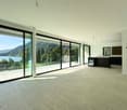 large floor to ceiling windows, tiled floor, balcony with glass walls