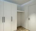 white wardrobe, wooden floor, open door