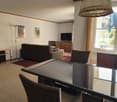 glass table, chairs, lamp, couch, carpet, television, side table, cabinets
