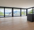 floor to ceiling windows, wooden floor, large balcony, lake view