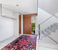 marble floor, tiled wall, staircase, wooden door, rug, balcony access