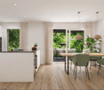 Open-concept kitchen and dining area with large windows overlooking a lush, green outdoor space. The kitchen features white cabinets, black countertops, and stainless steel appliances. The dining table is made of wood and seats six people, with green upho