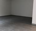 white walls, tile flooring, empty room, power outlet on the wall