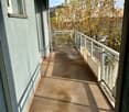carpeted balcony with metal railings