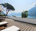 deck with outdoor furniture, trees, panoramic view of the lake and mountains