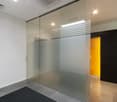 empty room, glass walls, white walls, black floor, yellow door