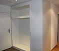 White built-in wardrobe, tiled floor, white doors, power outlets