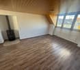 wooden floor, fireplace, white walls, windows, radiator, lamp