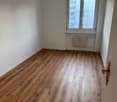 empty room, wooden floors, white walls, window with glass, white radiator on wall