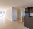 spacious kitchen with glass door leading to balcony, white walls, tiled flooring, embedded appliances