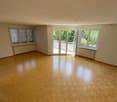 empty room with wooden floor, double glazed windows, sliding doors to balcony, radiators