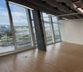 office room with large windows with view of airport and road outside