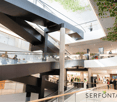 modern building, glass walls, escalators, people walking, shops, ceiling design