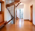 Wooden floor, glass and wood spiral staircase, open bathroom on first floor, open hallway