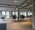 modern office design, carpeted floor, adjustable desks, metal columns, large windows