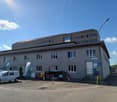 commercial building with a parking lot in front of it