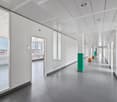 white walls, glass doors, ceiling panels, windows, gray flooring