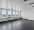 empty office room, large windows, white walls, grey flooring, HVAC systems