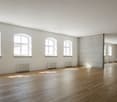 wide room, white walls, white ceiling, hardwood floors, multiple windows
