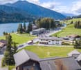 village in the mountains with houses, lake, mountains, road, greenery
