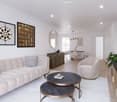 living room with couch, tables, tv, mirror and art