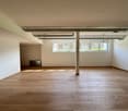 empty room, wooden floor, white walls, windows, central pillar