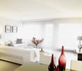 modern white furniture, large windows, glass table, decorative vases, indoor plant