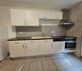 modern white kitchen, gas stove, oven, sink, refrigerator, tiled flooring