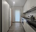 modern kitchen, white cabinets, gray tiles, oven, dishwasher, sink, light