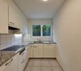 white cabinets, granite countertops, modern sink, cooking hob, extractor fan, dishwasher