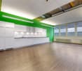 modern kitchen with wooden floors, white cabinets, green wall, kitchen with sink and cabinets, radiator, ceiling lamps, large windows