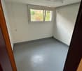 empty room, white walls, gray floor, small window